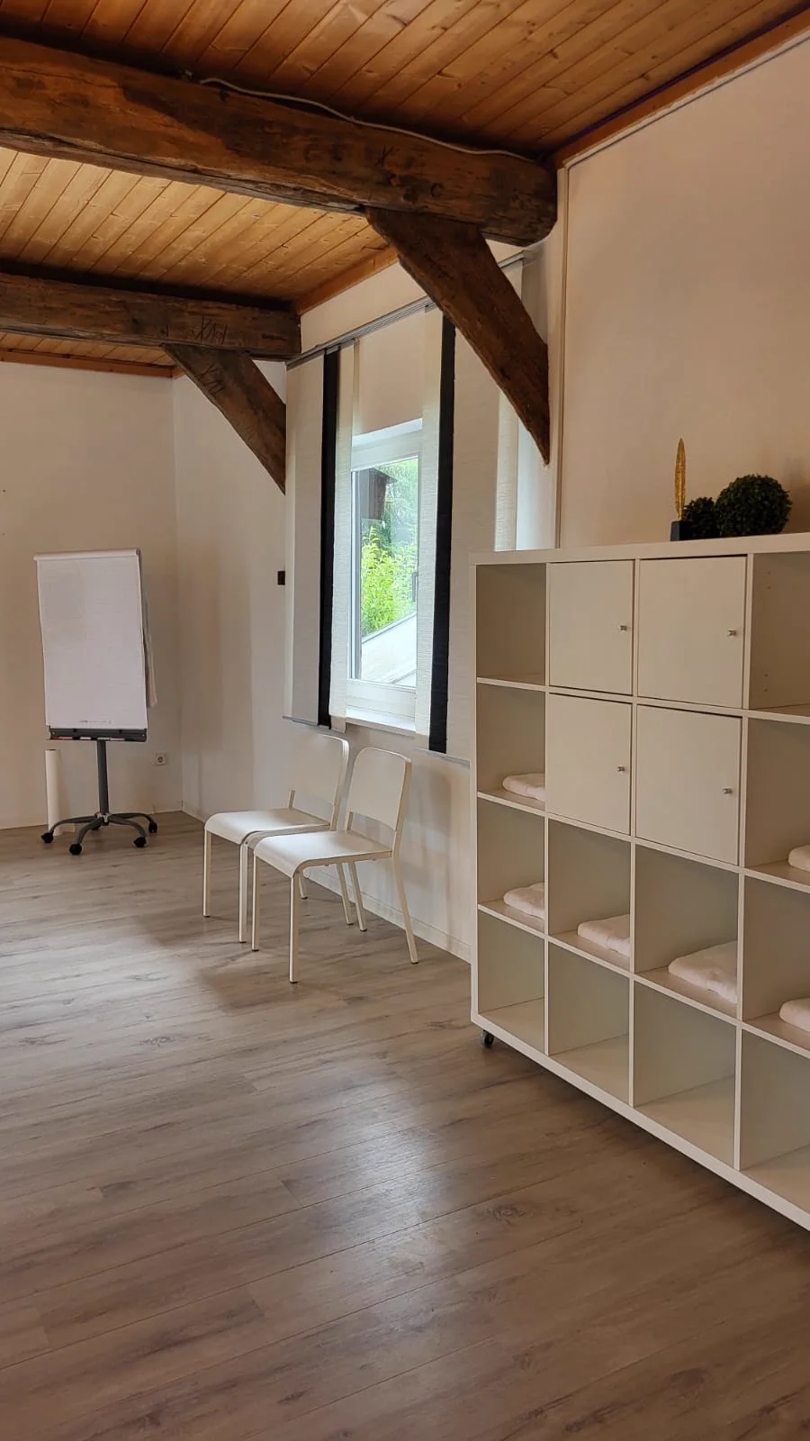 Schulungsraum mit Flipchart und Regal mit Handtüchern